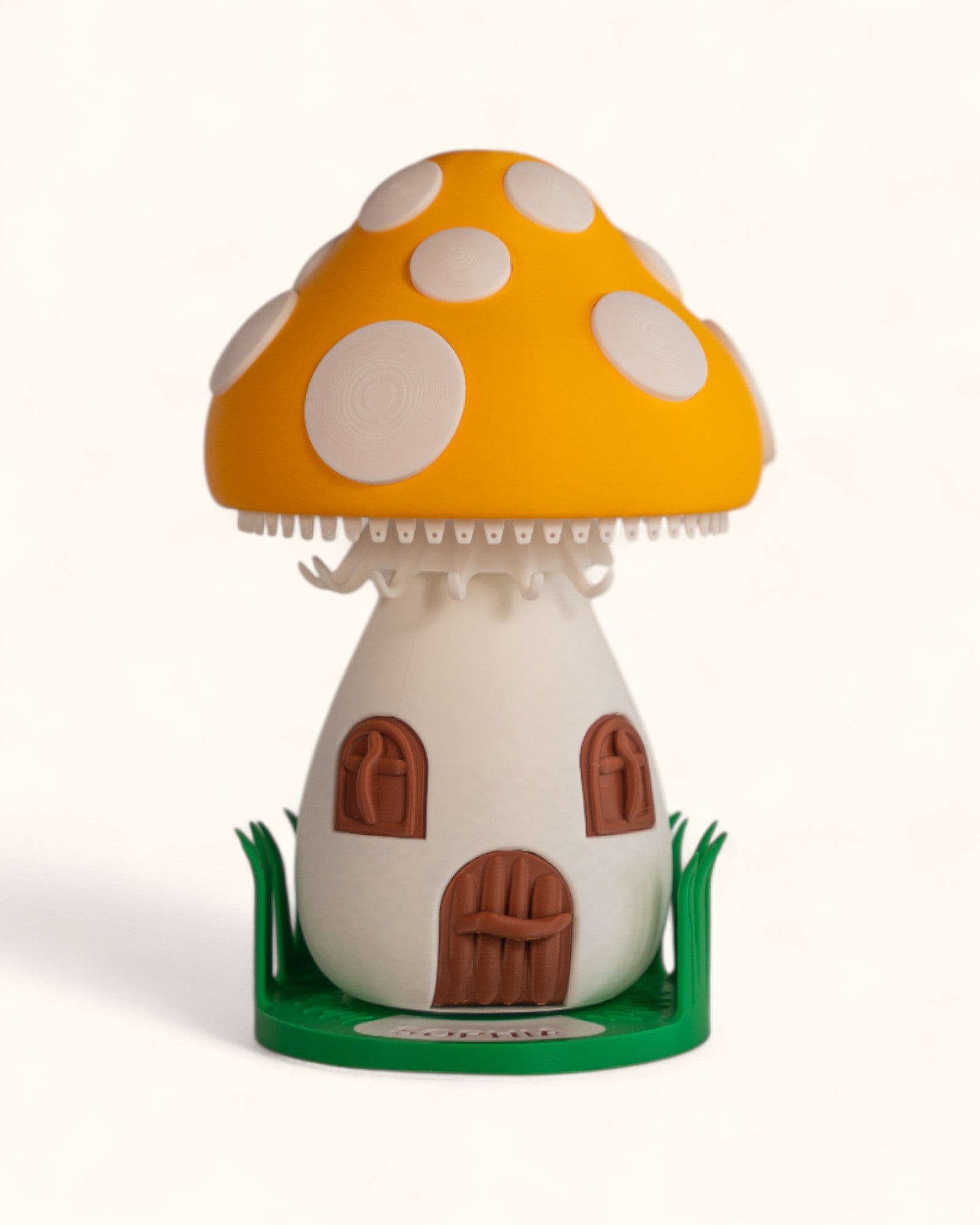 3D printed mushroom jewelry organizer with white spots, doors, windows as storage and green grass ring holder base and custom text printed on doorstep.