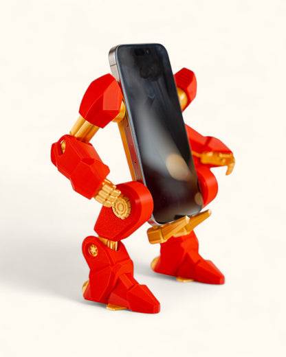 3D-printed mech-inspired phone stand with detailed armour plates, gear design, and hand feature for holding a charging cable, adjustable to fit most modern smartphones.